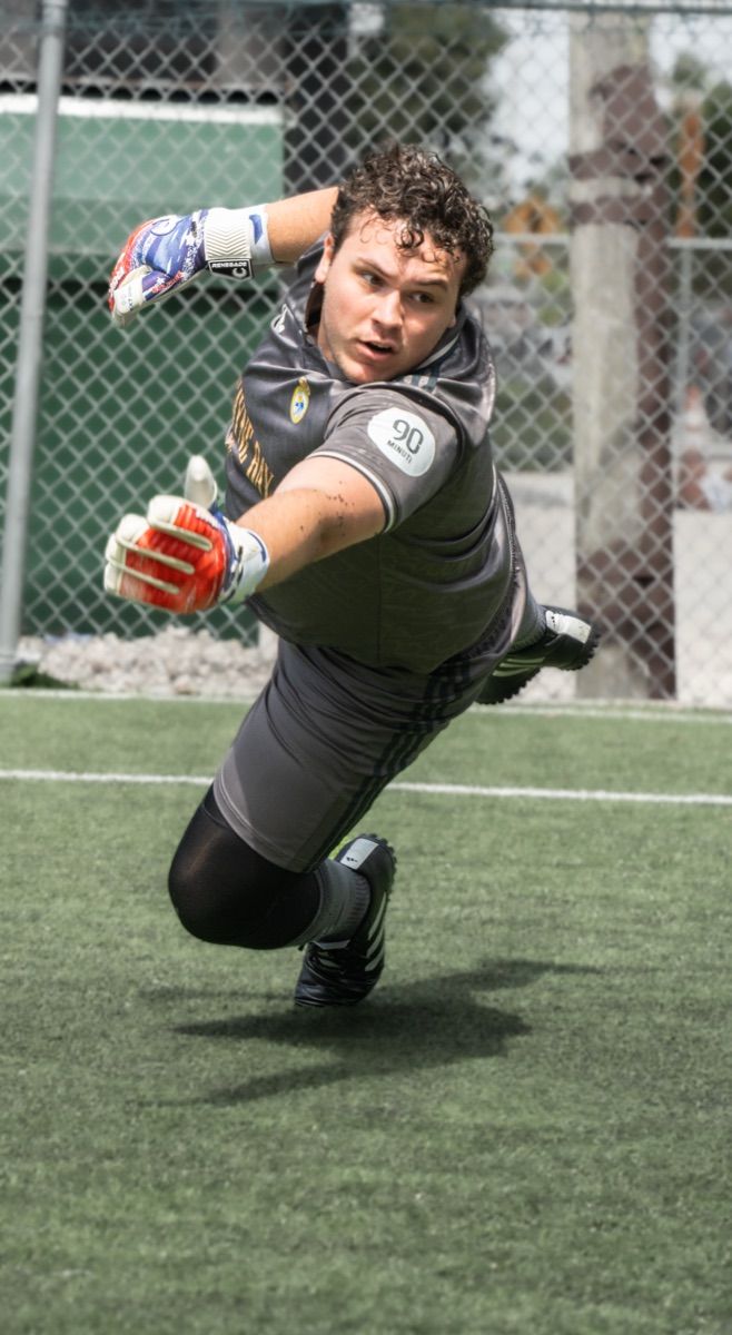 Goalkeeper diving to make a save in a CFL match